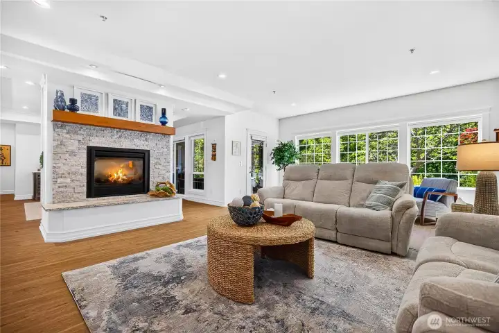 Spacious living room with gas fireplace, large windows, and an open layout designed for comfortable everyday living.