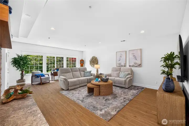 Bright gathering space with abundant natural light and peaceful greenbelt views just beyond the windows.