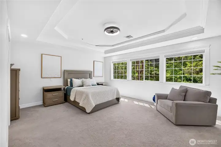 Light-filled primary retreat offering a comfortable layout and tranquil views of the surrounding greenery.