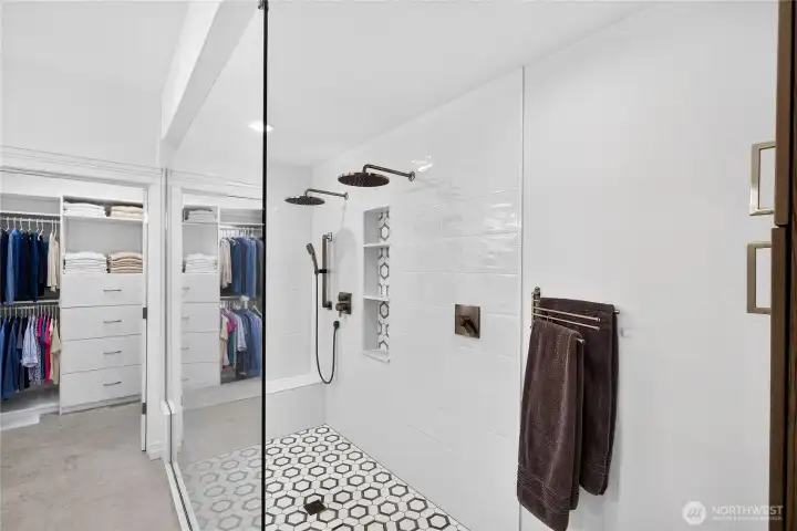 Walk-in shower featuring modern tile finishes, accessibility enhancements, and a clean contemporary design.