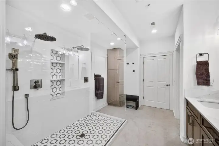 Spa-inspired primary bathroom with oversized walk-in shower, quartz surfaces, and updated fixtures throughout.