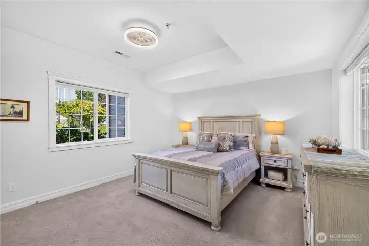 Guest bedroom offering comfortable accommodations, abundant natural light, and flexible space for family or visitors.