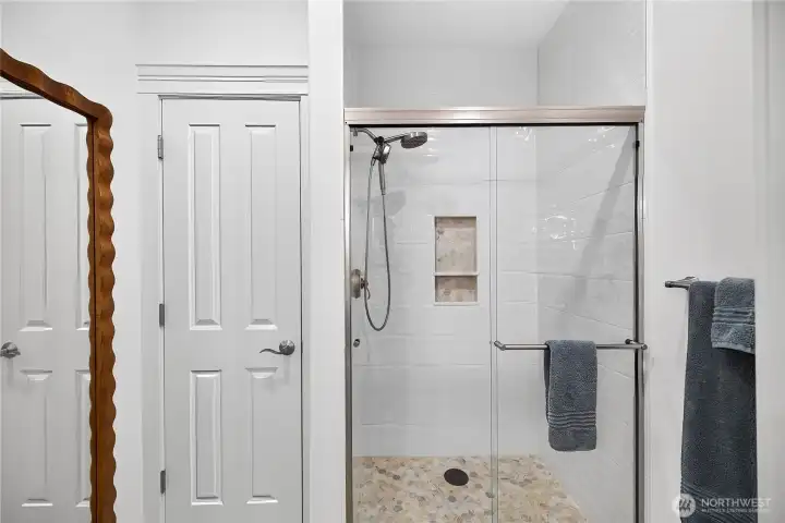 Updated guest bathroom featuring a walk-in shower, modern fixtures, and easy-access design.