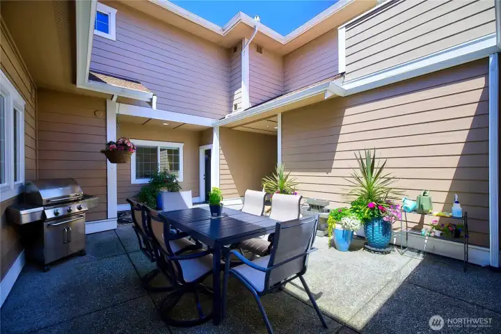 Low-maintenance courtyard patio ideal for outdoor dining, entertaining, and enjoying the peaceful surroundings.