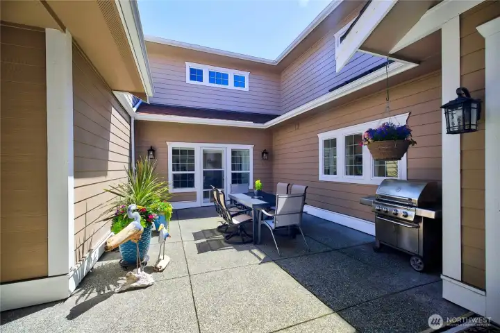 Private outdoor living space with room to relax, garden, or host guests in a sheltered courtyard setting.