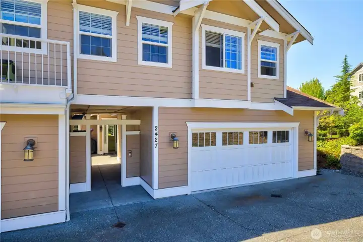Exterior view showcasing the attached two-car garage, private entrance, and convenient ground-floor access with no stairs.