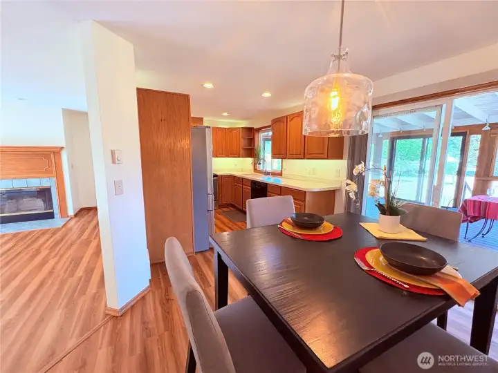 Open Dining Room off Living Room with Entrance to Glassed in Porch