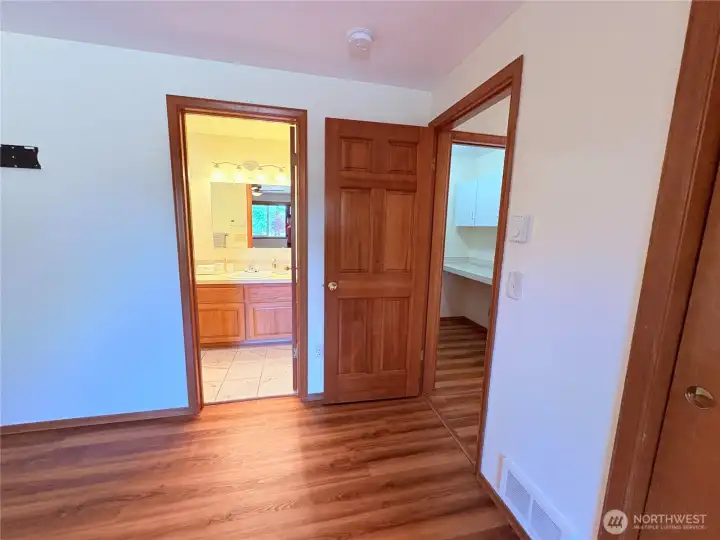 Primary Suite entrance - Peek-a-boo view of laundry room & Primary ensuite