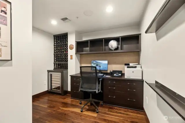 Den with built in desk and storage. Plus wine fridge and rack.