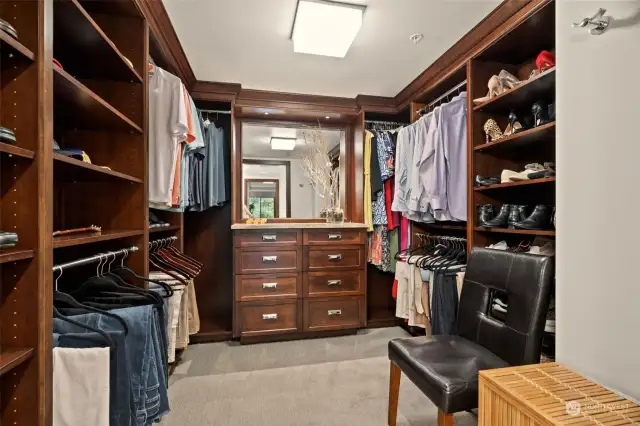 Walk-in closet with custom built in cabinetry.