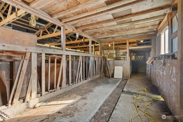 Barn interior with livestock area and head gates.