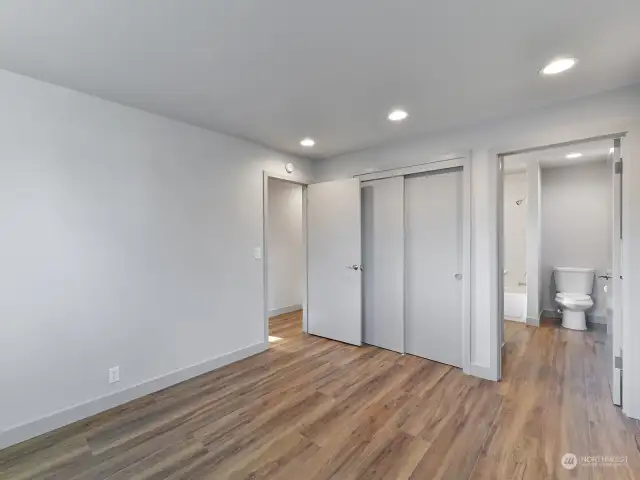 Primary bedroom with access to the bathroom.