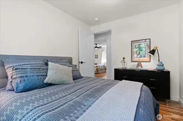 Continuous hardwood flooring runs through three of the four bedrooms