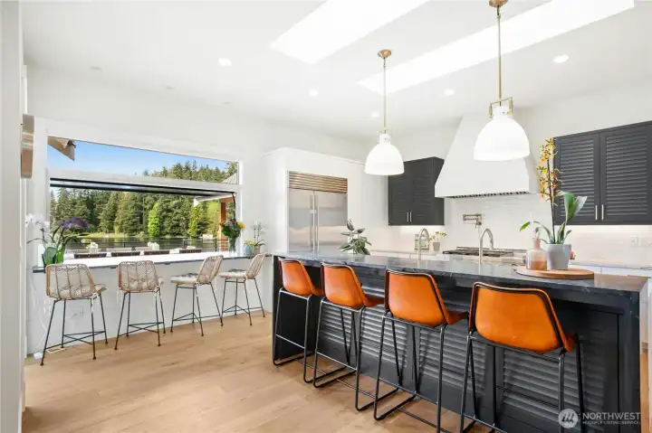 A chef’s kitchen with high-end appliances and a built-in espresso maker—you’ll never need to buy Starbucks again!