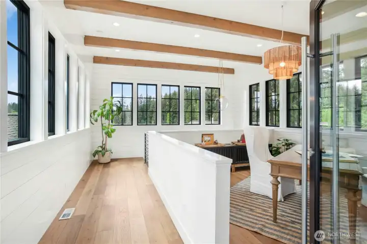 The entry tower features a home office area with walls of windows facing all directions.