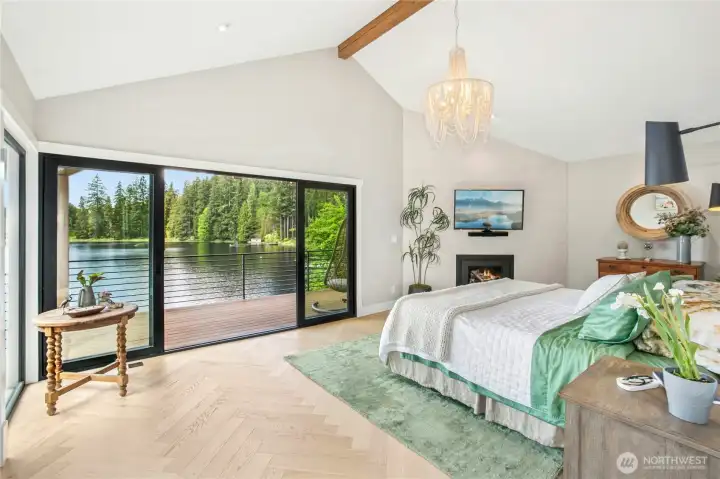 The inviting primary suite captures unobstructed lake views. Imagine waking up every morning to pristine views and a cozy fire.