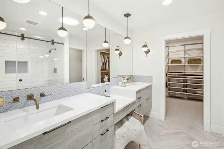 The ensuite primary bath and walk-in closet with built-ins.