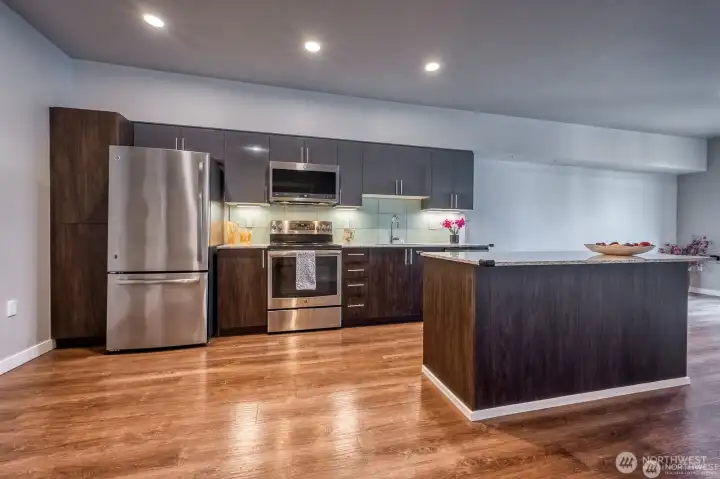 Quartz countertops and stainless steel appliances.