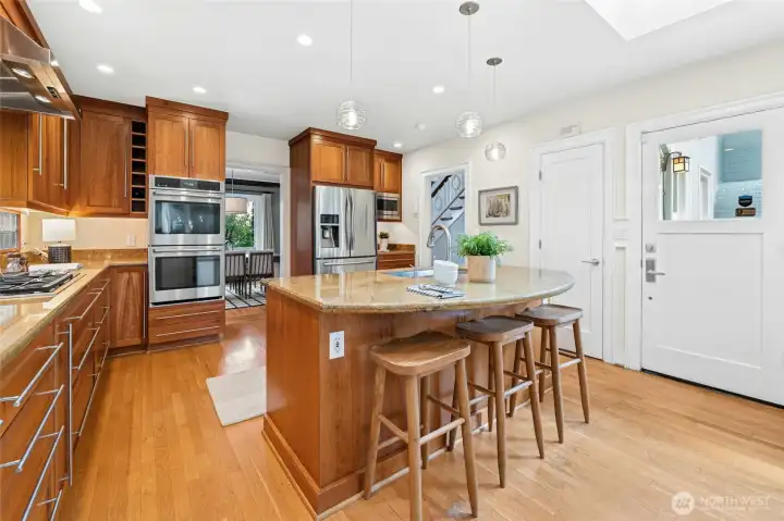 The kitchen was updated with wood cabinets running up to the ceiling, breakfast island and dining area.