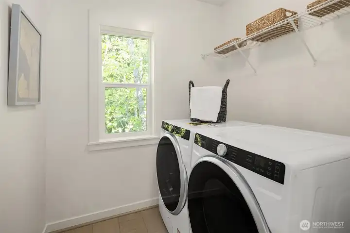 Full appliance package including washer, dryer, and refrigerator are included in Homesite 7.  Photos of a staged Marigold home. Surfaces and finishes will vary from subject home.