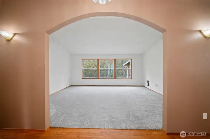 Walk into this inviting home, featuring high ceilings and an arched entry into the living room.