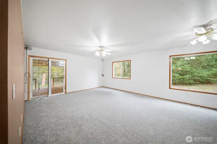 Down the hall you enter the family room with access to the covered deck. Surrounded with beautiful greenery out every windwo.