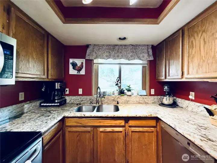 Kitchen with stainless steel appliances, amply cupboards and granite countertops, LVP flooring, with updated lighting