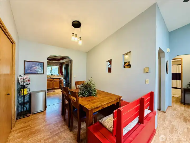 Dining area with built in bench with storage, full wall pantry, LVP, vaulted ceilings