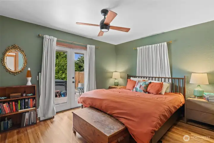 The primary bedroom has that perfectly cozy feel with the original hardwood floors and the double french doors opening out to your own private oasis.