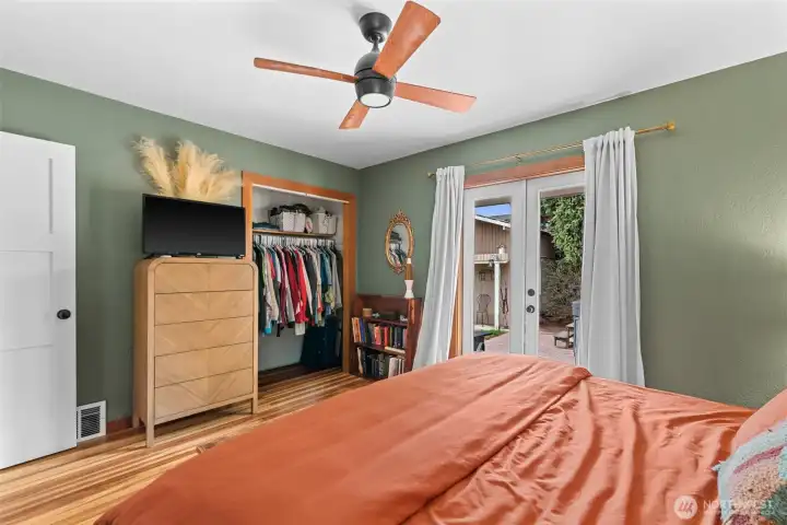 The primary with french doors opening out to the patio.