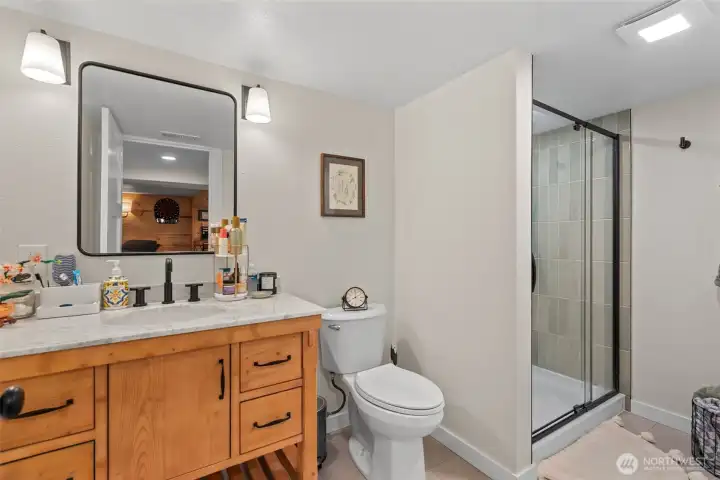 This brand new bathroom added to the downstairs in just 2024 makes it easy to have everything you need all in one space. The LVP flooring and modern tile makes this space feel like you are a world away.
