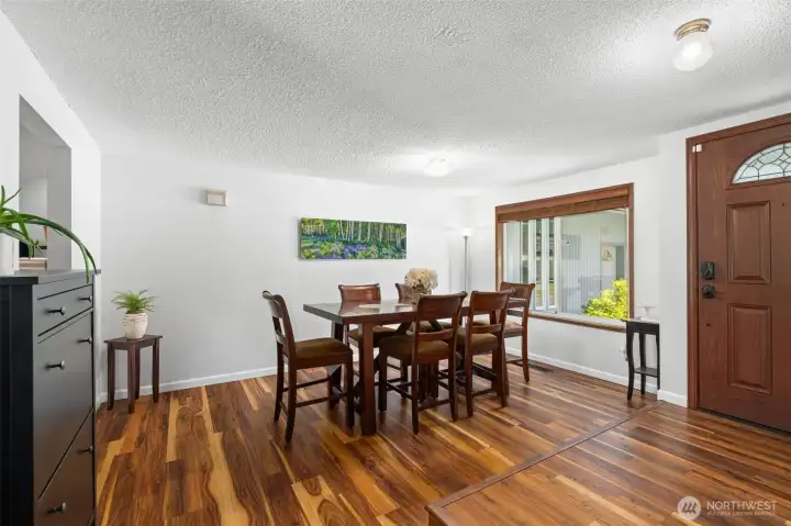 Light-filled dining area with updated flooring and large picture windows. Light-filled dining area with updated flooring and large picture windows.