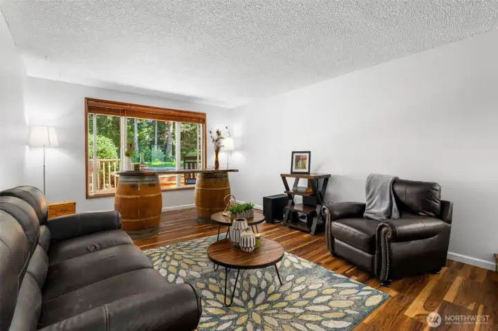 Another view of the living room with abundant natural light and open layout perfect for relaxing or gathering with guests. Freshly painted. Another view of the living room with abundant natural light and open layout perfect for relaxing or gathering with guests. Freshly painted.
