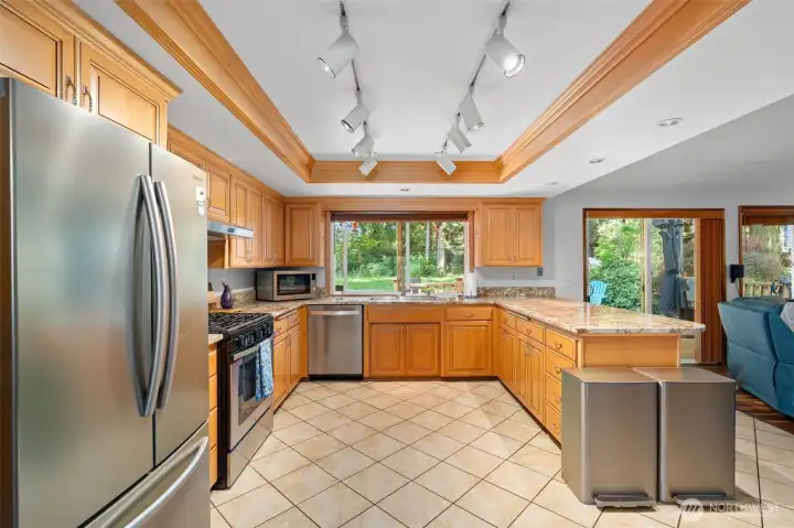 Expansive chef’s kitchen featuring abundant cabinetry, extensive granite countertop space, stainless steel appliances, and an exceptionally spacious, functional layout ideal for both everyday living and effortless entertaining. Expansive chef’s kitchen featuring abundant cabinetry, extensive granite countertop space, stainless steel appliances, and an exceptionally spacious, functional layout ideal for both everyday living and effortless entertaining.