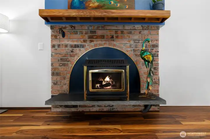 Cozy gas fireplace with a classic brick surround and wood mantel creates a warm and inviting focal point, adding timeless charm and comfort to the living space. Cozy gas fireplace with a classic brick surround and wood mantel creates a warm and inviting focal point, adding timeless charm and comfort to the living space.