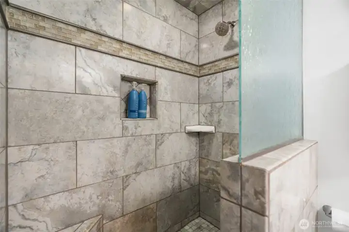 Beautifully updated walk-in shower with custom tile work, modern finishes, and built-in niche shelving for a spa-like experience. Beautifully updated walk-in shower with custom tile work, modern finishes, and built-in niche shelving for a spa-like experience.