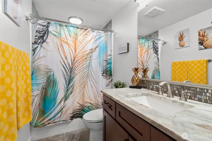 Updated full bathroom featuring quartz countertops, modern cabinetry, stylish finishes. Updated full bathroom featuring quartz countertops, modern cabinetry, stylish finishes.