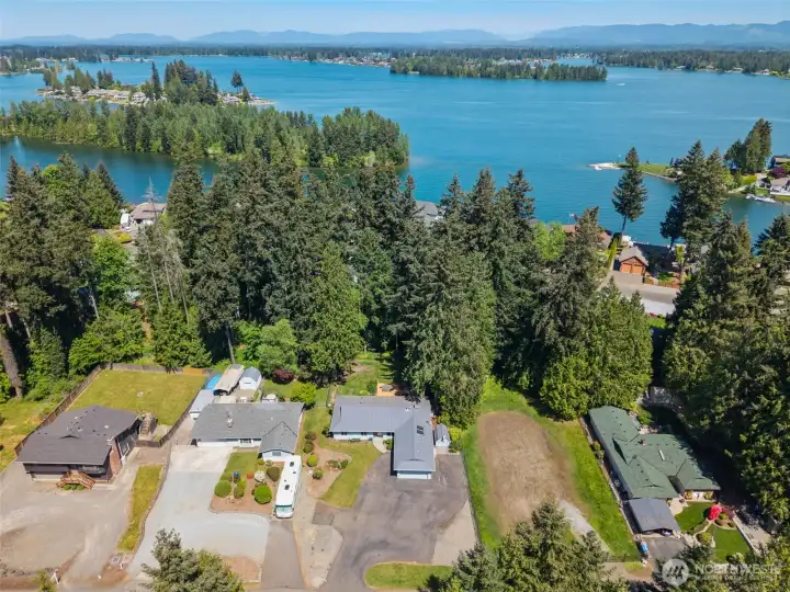 Exceptional aerial view showcasing the home's spacious lot, private wooded setting and close proximity to beautiful Lake Tapps. Exceptional aerial view showcasing the home's spacious lot, private wooded setting and close proximity to beautiful Lake Tapps.