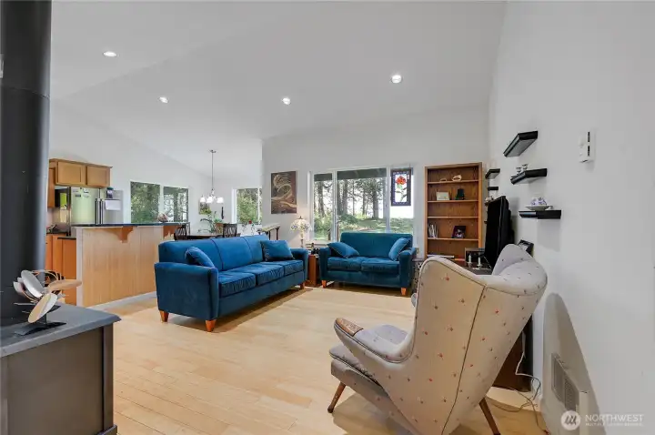 Upon entering, you will notice the bamboo floors, captivating view, and tall cathedral ceilings. The propane fireplace is on the left.