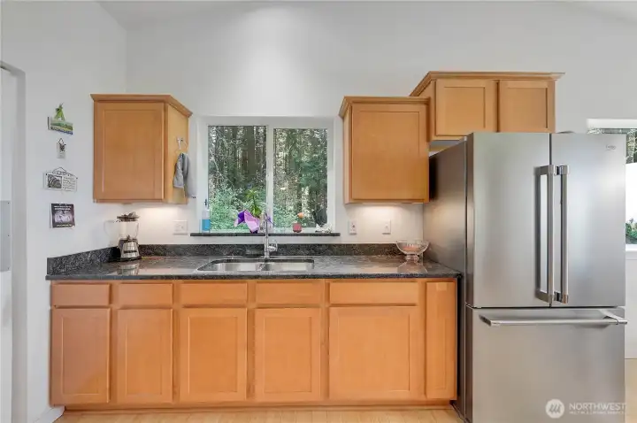 The kitchen features granite countertops, plenty of storage space, and stainless-steel appliances.