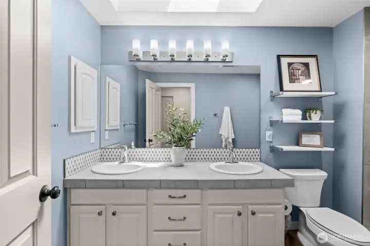 A well-appointed and spacious shared bathroom featuring modern finishes, excellent storage, and a layout optimized for convenience. A well-appointed and spacious shared bathroom featuring modern finishes, excellent storage, and a layout optimized for convenience.