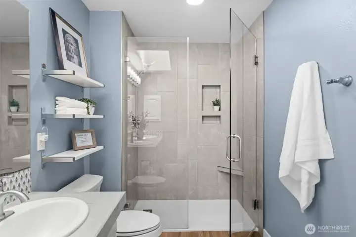 Enjoy this gorgeously tiled shower with a niche shelve and seamless glass showers. Enjoy this gorgeously tiled shower with a niche shelve and seamless glass showers.