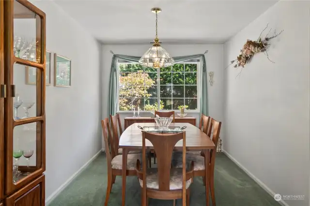 Dining room off the living room, also features large window.