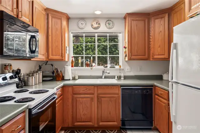 Kitchen features ample storage, recessed lighting and window above the sink.