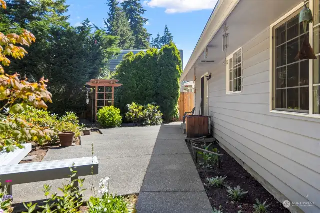 Enjoy the mature landscaping that surrounds this property on the large patio and built-in bench.