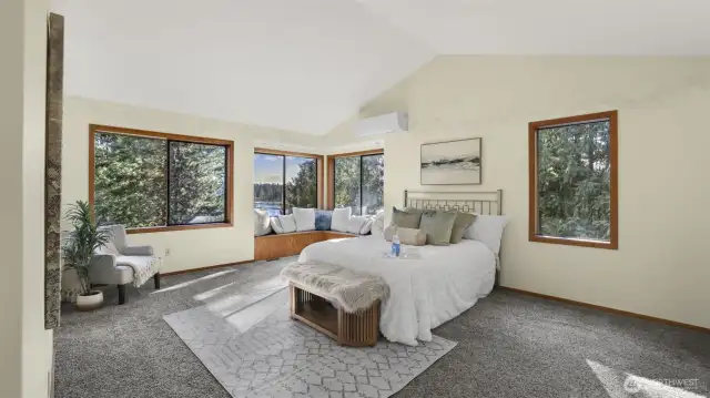 Serene and stylish primary retreat is located upstairs featuring a mini split for year round comfort, window seat for relaxing and taking in the breathtaking outdoor views, and spa-like en suite.