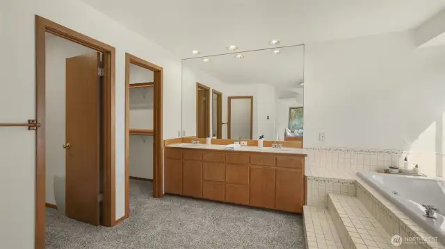 This oversized primary bathroom offers two walk-in closets for ample storage space!