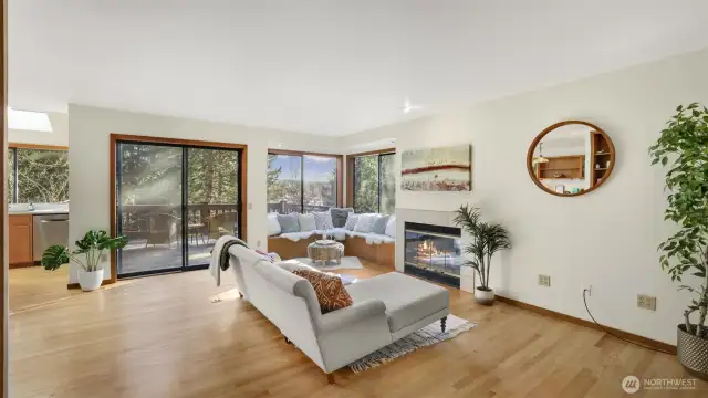 Warm and inviting living room featuring a cozy fireplace and seamless access to the outdoor deck.