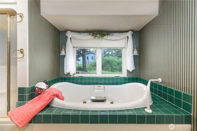 Primary jetted tub and separate walk-in shower.