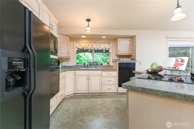 Kitchen has custom cabinets and is a great room concept.